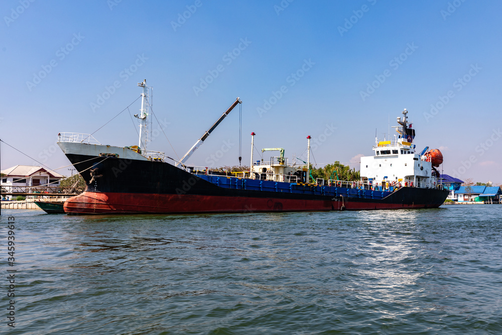 Oil tanker ship or oil cargo ship docked at port on Maeklong river Thailand