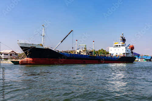 Oil tanker ship or oil cargo ship docked at port on Maeklong river Thailand