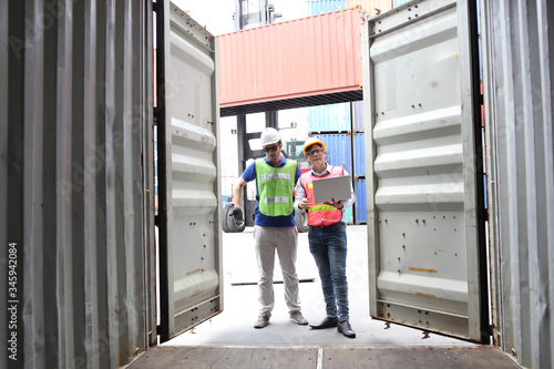 Engineering group working and they are loading container for support logistics and import export business