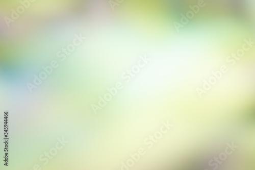 multicolor abstract background of blended pastel shades of yellow, green, purple and white