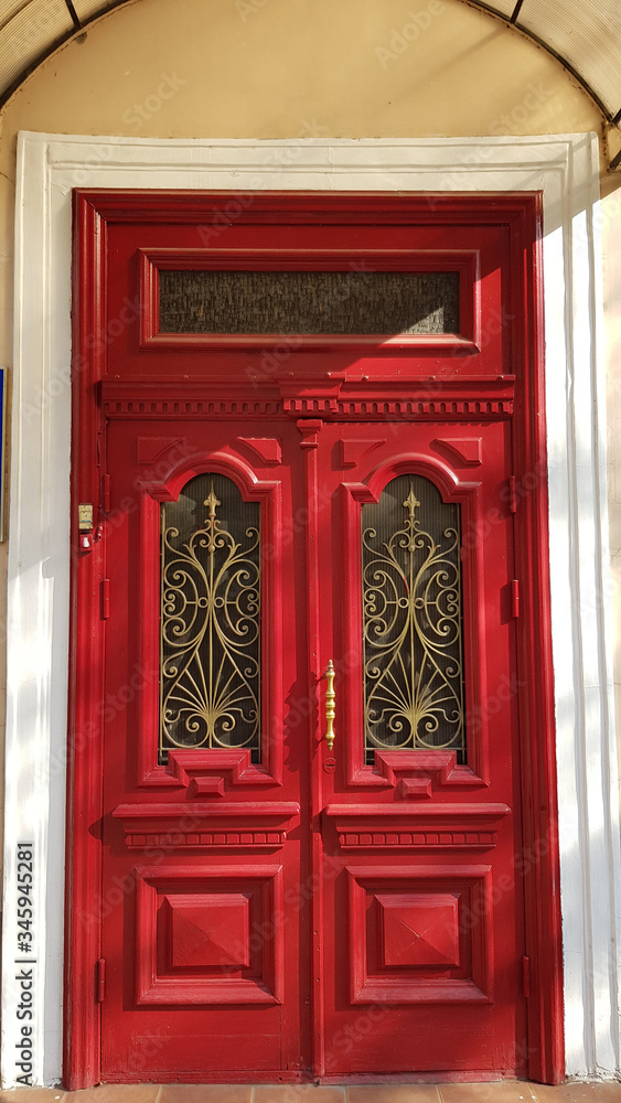 old red door. Entrance to ornate red door of historic building in European city Odessa of Ukraine