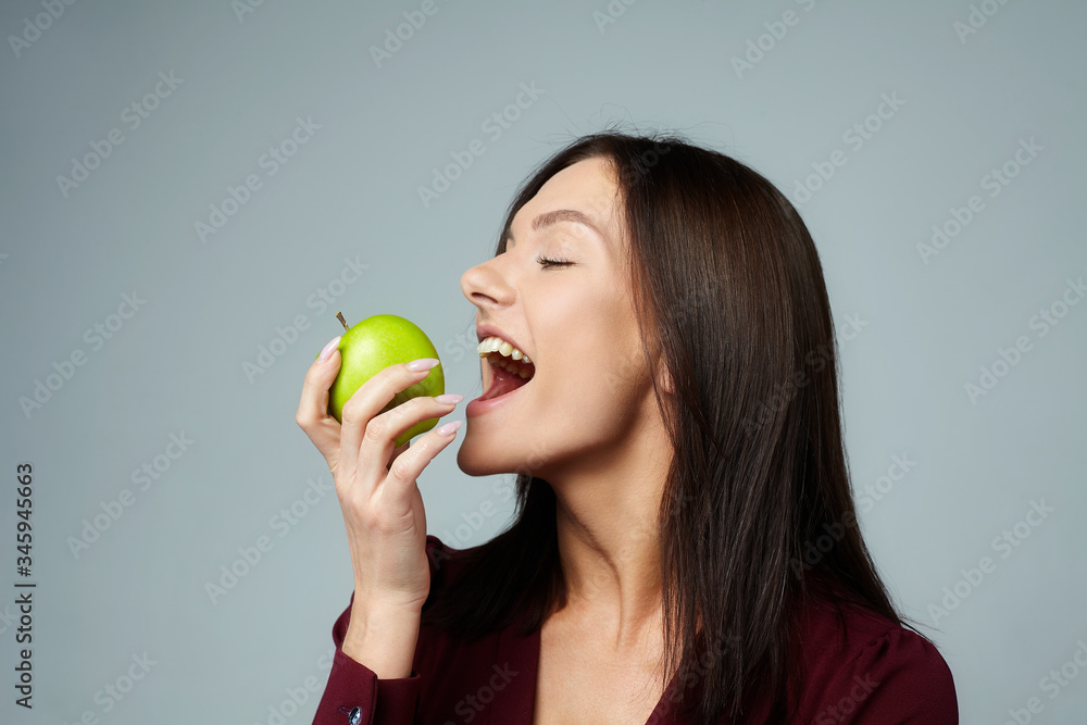 girl with a ripe green Apple on a white background girl with a ripe green Apple on a white background