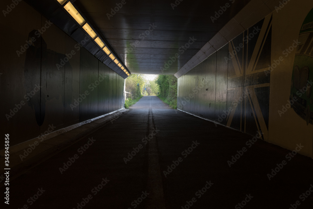 tunnel of light for pedestrians underneath leading to park
