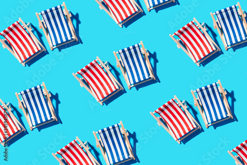 Fotografering Deck chairs pattern on blue paper background