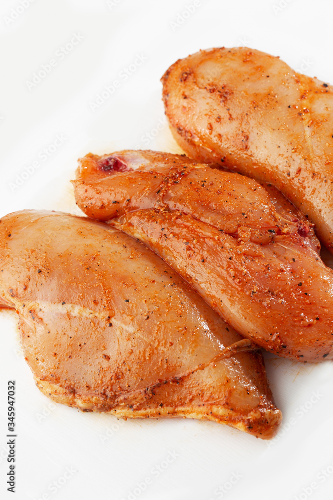 Marinated fillet isolated on a white background. Raw chicken breast fillets. top view with copy space. Flat lay composition with raw chicken breasts. Space for text. Meat shop. Marinated fillet isolated on a white background. Raw chicken breast fillets. top view with copy space. Flat lay composition with raw chicken breasts. Space for text. Meat shop.
