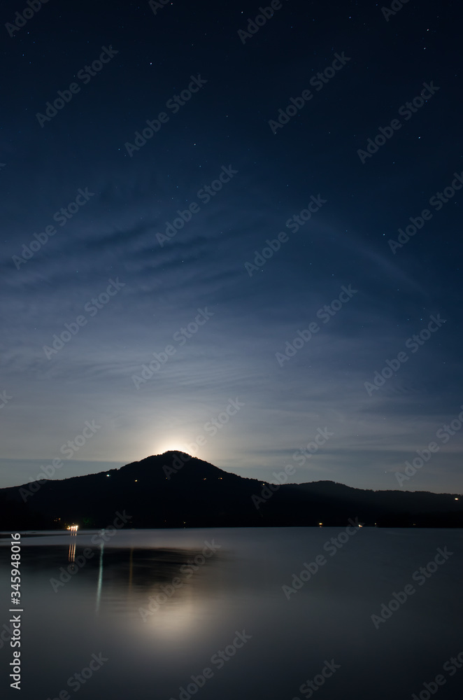 Moonrise with stars, clouds, and mountains at Lake Burton, Georgia.