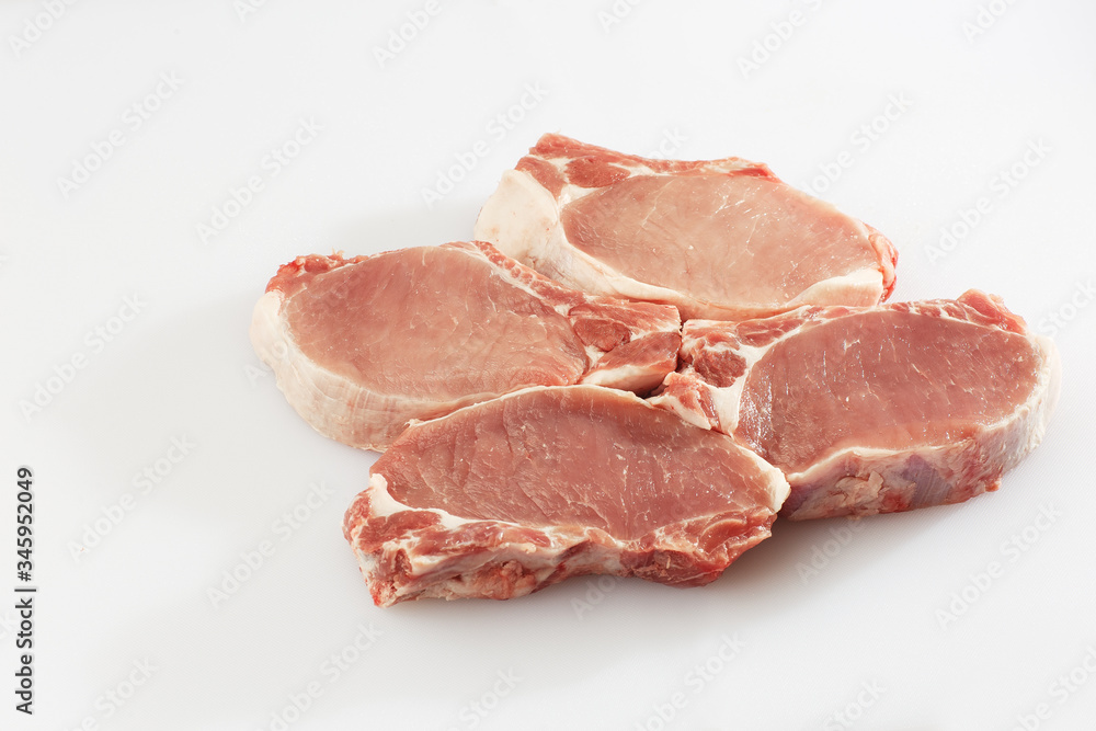slices pork loin on a white background. Raw pork. Advertising for meat shop and farm. Various kinds of meat and ready to cook concept. Top view. Space for text slices pork loin on a white background. Raw pork. Advertising for meat shop and farm. Various kinds of meat and ready to cook concept. Top view. Space for text