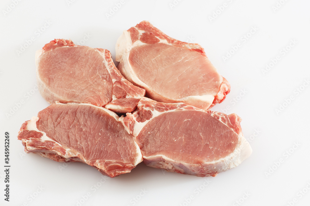 slices pork loin on a white background. Raw pork. Advertising for meat shop and farm. Various kinds of meat and ready to cook concept. Top view. Space for text