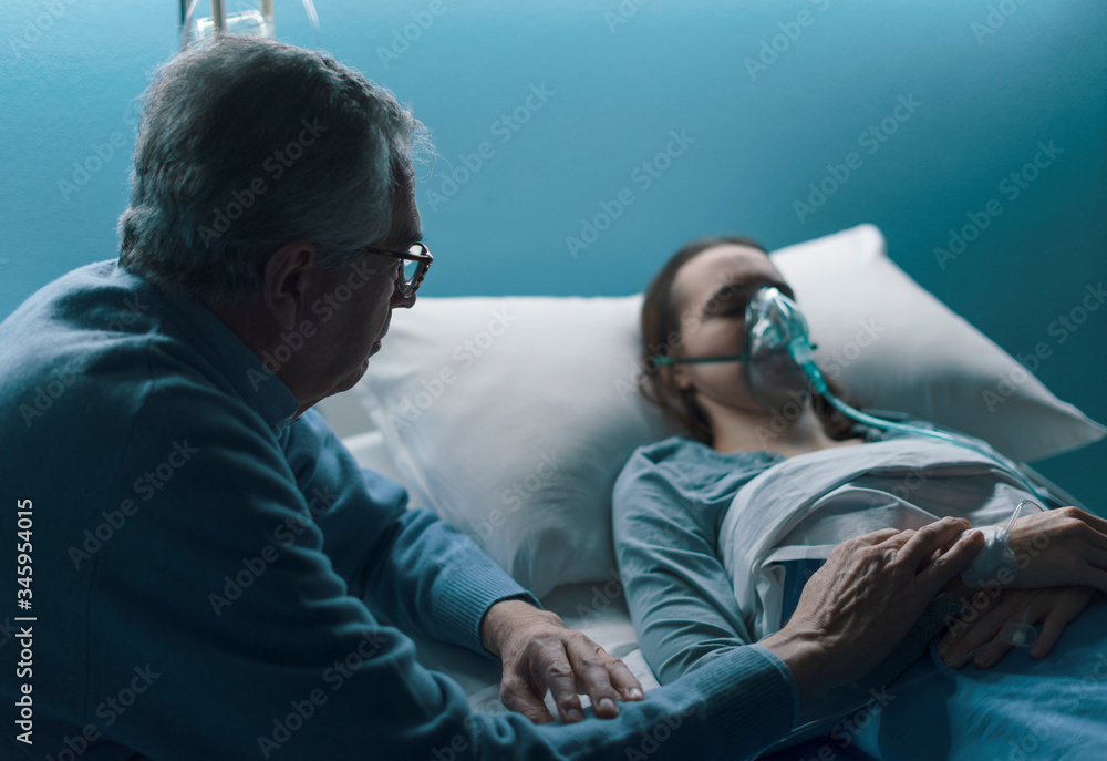 Senior man assisting her daughter at the hospital