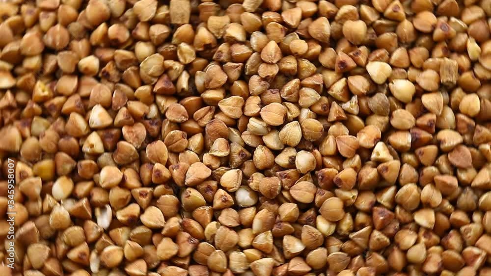 Buckwheat raw bulk rotate, top view, spinning slowly in a circle, close up. Buckwheat raw bulk rotate, top view, spinning slowly in a circle, close up.