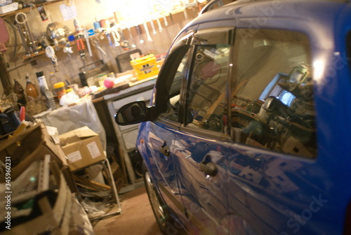 car in a garage near a workbench with tools