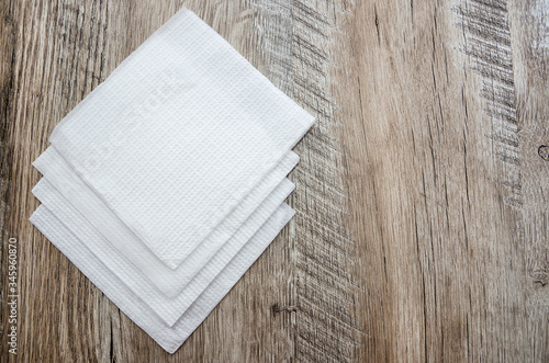 white napkins on a wooden background. copy space.