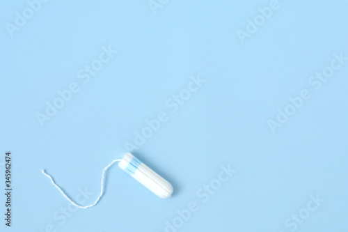 Medical female flyeng tampon on a pink background. Hygienic white tampon for women. Menstruation, means of protection. photo