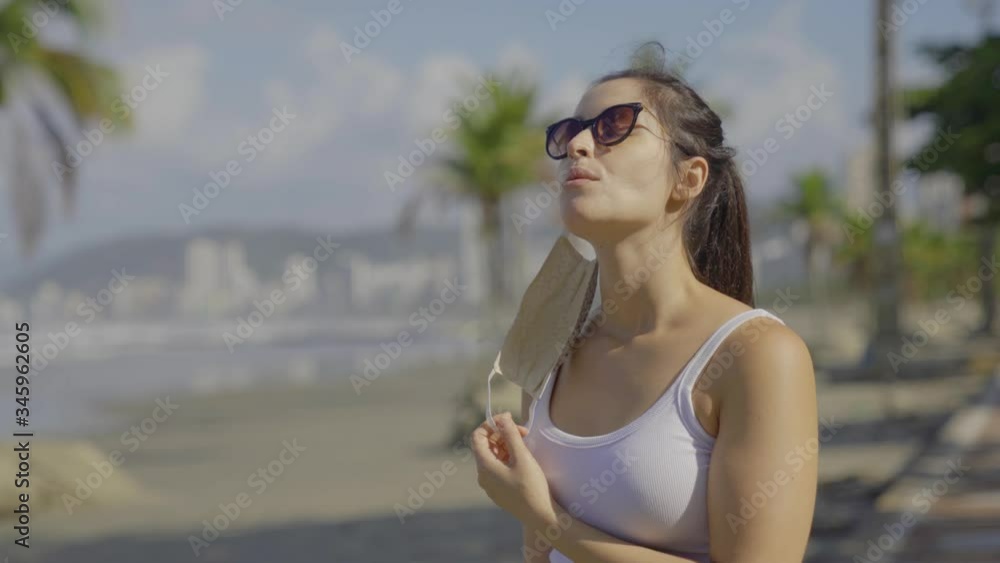 woman on the beach take off face mask to breath fresh air during corona virus quarantine. Hopeful to overcome corona virus outbreak pandemic
woman on the beach take off face mask to breath fresh air during corona virus quarantine. Hopeful to overcome corona virus outbreak pandemic