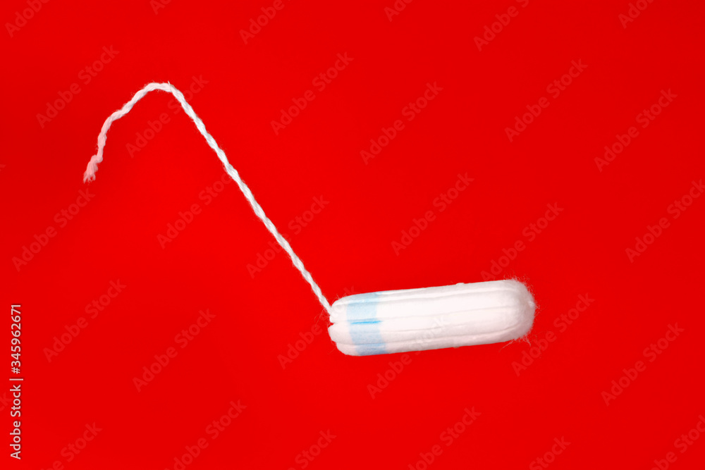 Medical female flyeng tampon on a pink background. Hygienic white tampon for women. Menstruation, means of protection. Medical female flyeng tampon on a pink background. Hygienic white tampon for women. Menstruation, means of protection.