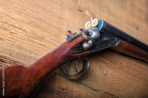 An old two-barrel hunting rifle on the table.