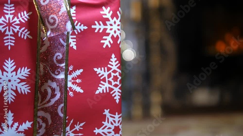 Gift Bag presents for Christmas near Fireplace. Decorative Snowflakes package. Isolated close-up. photo