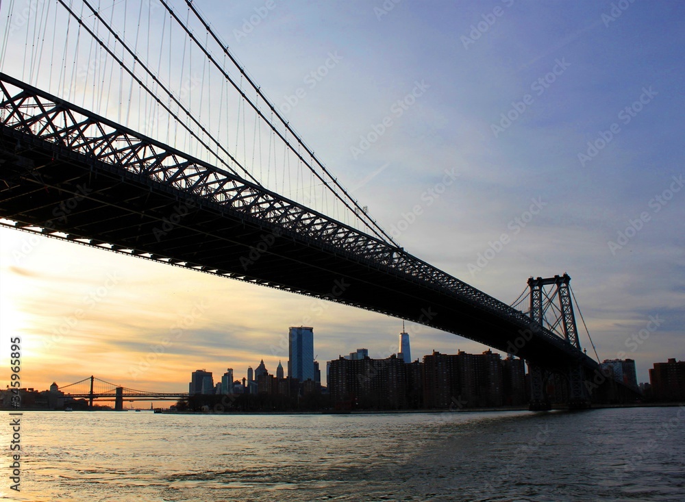 New york, USA - 20/12/2019: williamsburg bridge in New York Manhattan skyscrapers behind at sunset - stock photo