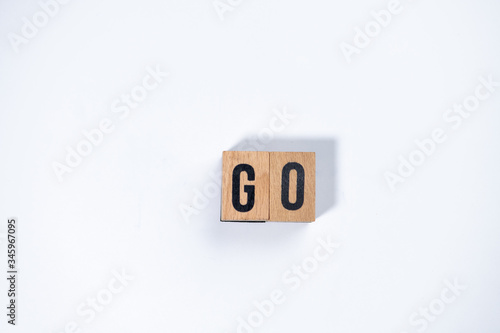 " GO " text made of wooden cube on White background.