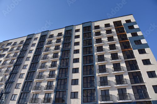 Construction of a new multi-storey building. The facade building with windows and balconies. The frame of the building is made of concrete. Residential building architecture background