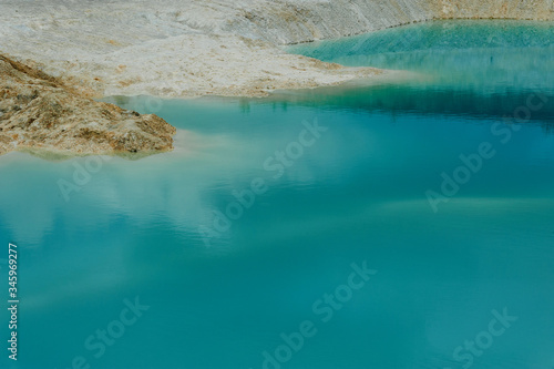 turquoise water and white shore in a kaolin quarry