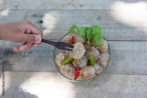 Steamed tapioca dumpling balls with pork is dessert in a bowl, Thailand call Sa Ku Sai Moo. photo