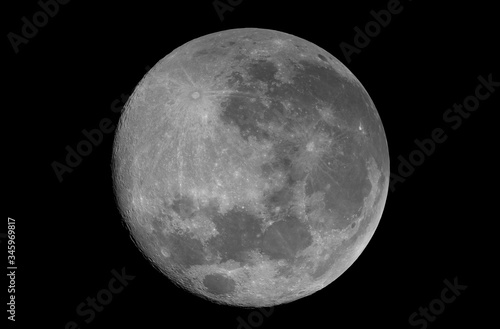 Super full phase Moon, isolated in the black space, with no star and some creaters in detail.