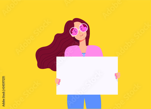 Beautiful brunette girl with long hair holding empty banner. Woman holds a poster with place for text.