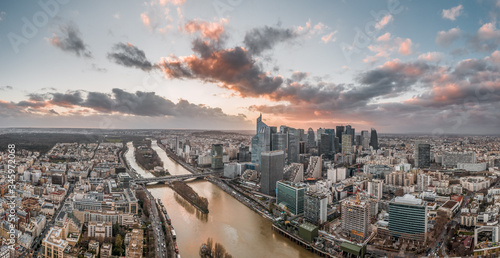 Dec 24, 2019 - Paris, France: Panoramic aerial drone shot of la defense skyscraper complex with clouds during sunset hour photo