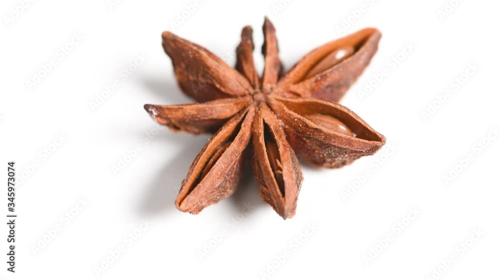 spice Badian or star anise rotates on the table on a white background close up spice Badian or star anise rotates on the table on a white background close up