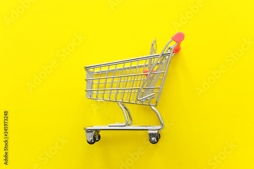 Image of shopping cart over yellow background