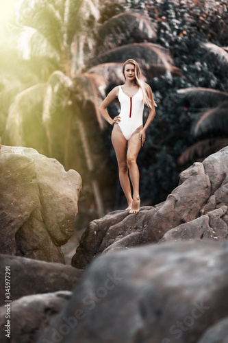 Beautiful young woman in bikini on the tropical beach