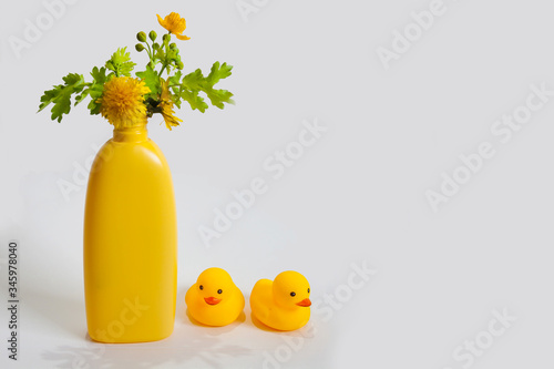 baby shampoo with herbs on a white background, rubber yellow ducks