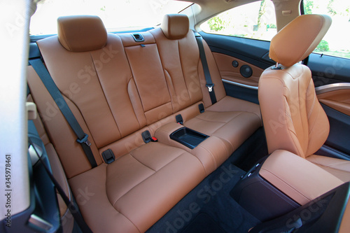 Rear seats of tan leather car interior 