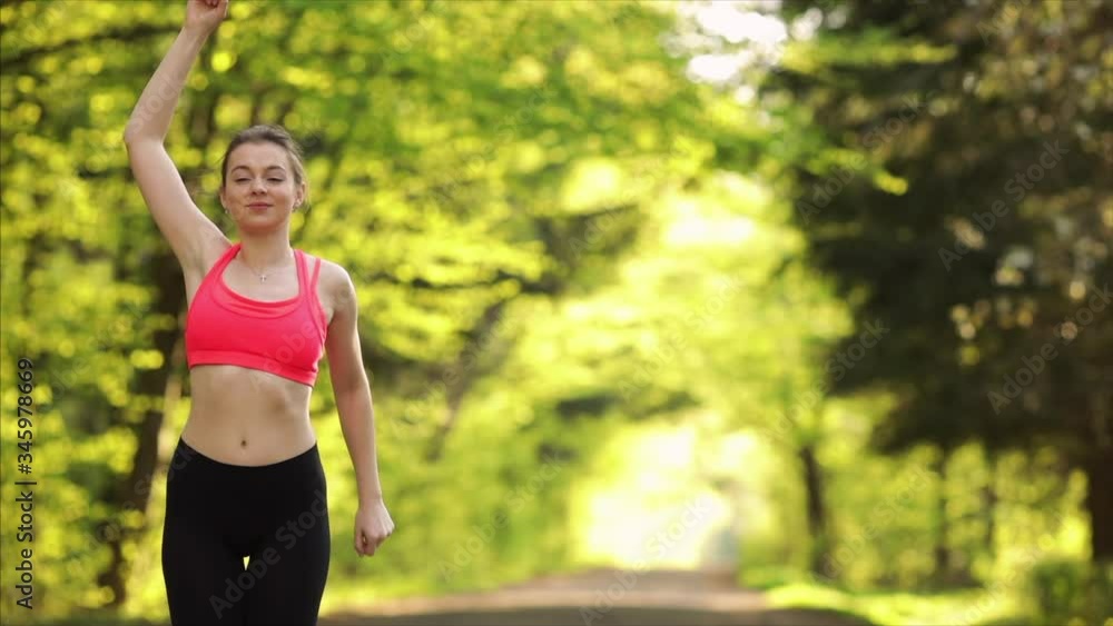Fitness woman doing exercise on warming up at outdoor workout in summer park. fitness training outdoor. Sport girl stretching muscles before workout. Fitness woman doing exercise on warming up at outdoor workout in summer park. fitness training outdoor. Sport girl stretching muscles before workout.