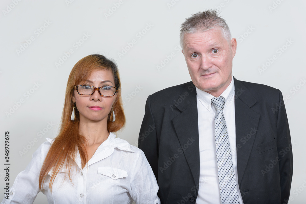 Mature multi ethnic business couple working together Mature multi ethnic business couple working together