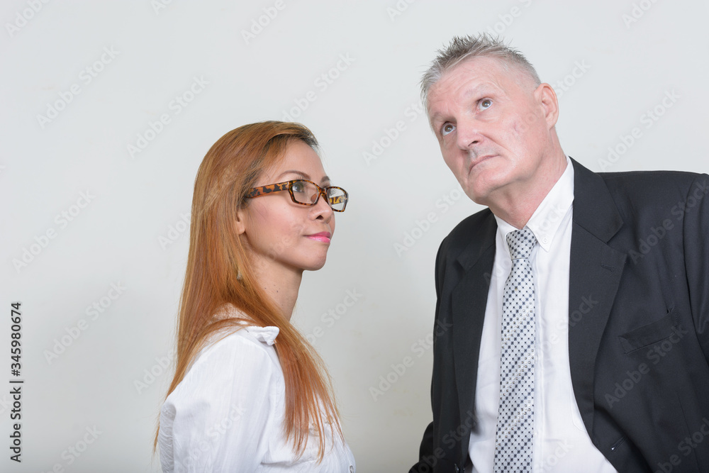 Mature multi ethnic business couple working together Mature multi ethnic business couple working together