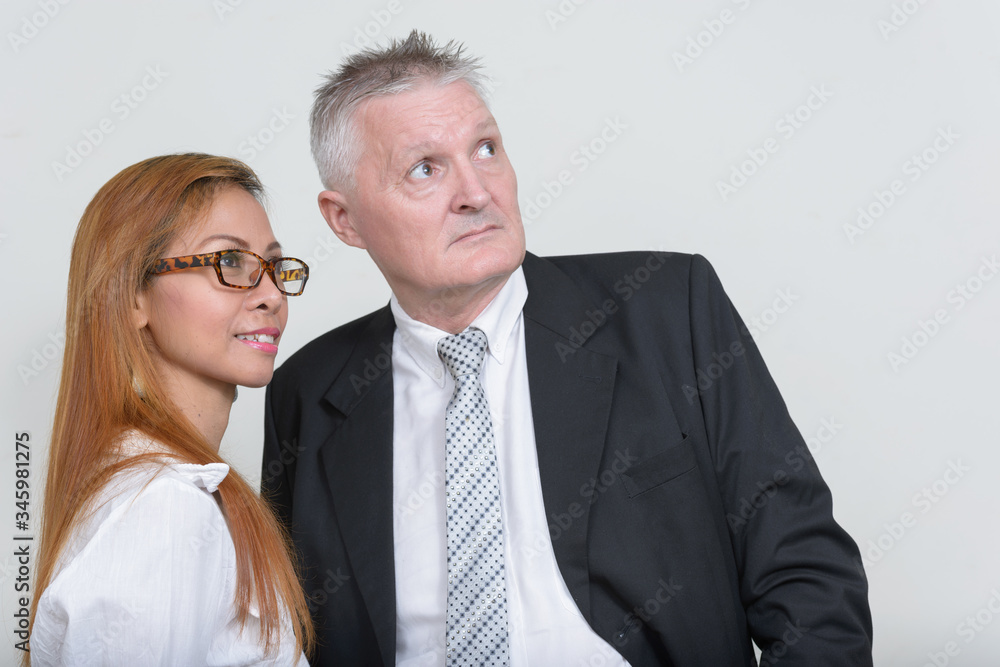 Happy mature multi ethnic business couple working together Happy mature multi ethnic business couple working together