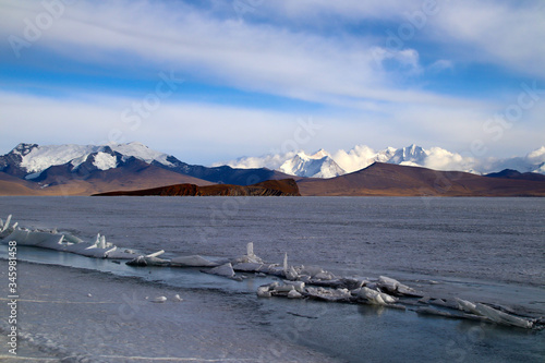 Ice lake, snow mountain, brown distant mountain, gorgeous cloud, a plateau beauty 