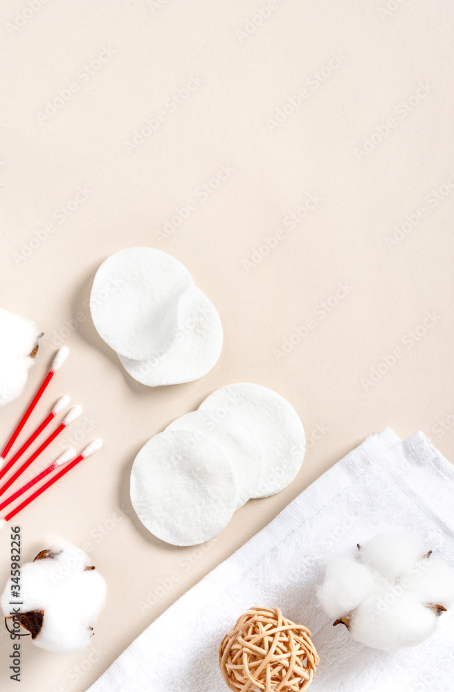 Cotton pads, towel and cotton buds on a light background, top view, free space for text. Cotton products for makeup removal and skin cleansing, flat lay, copy space. Cotton pads, towel and cotton buds on a light background, top view, free space for text. Cotton products for makeup removal and skin cleansing, flat lay, copy space.