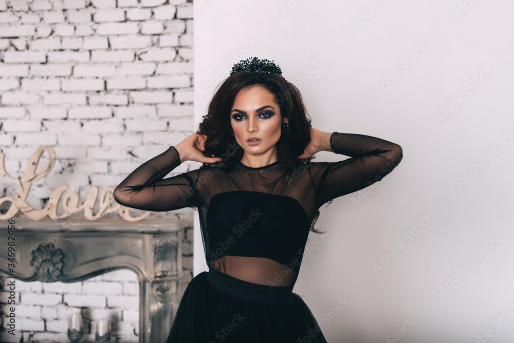 a beautiful bride in a white glittering wedding dress with brown hair poses in a photo Studio a beautiful bride in a white glittering wedding dress with brown hair poses in a photo Studio