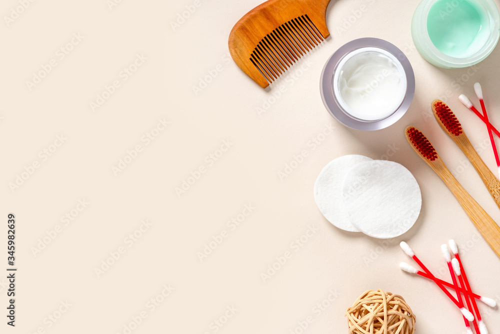 Flat lay composition with hygiene and body care products. Toothbrush, comb, cream, soap, cotton pads and cotton buds on a light background, top view, free space for text. Flat lay composition with hygiene and body care products. Toothbrush, comb, cream, soap, cotton pads and cotton buds on a light background, top view, free space for text.