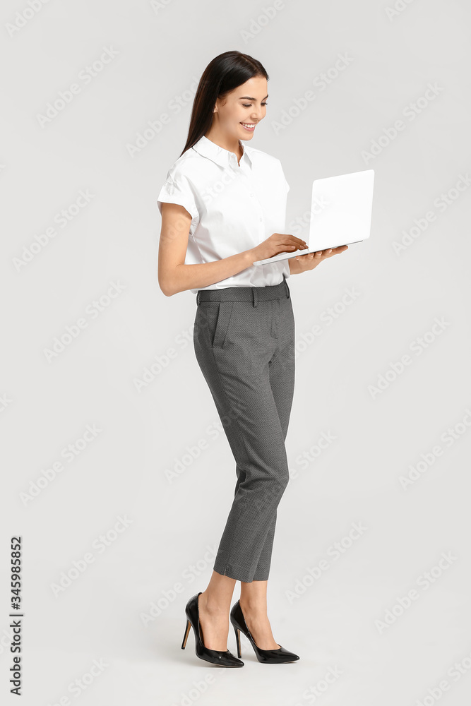 Beautiful young secretary with laptop on white background Beautiful young secretary with laptop on white background