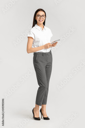 Beautiful young secretary on white background photo