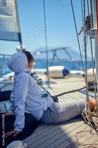 Summertime cruising enjoying on a sailing boat at open sea.