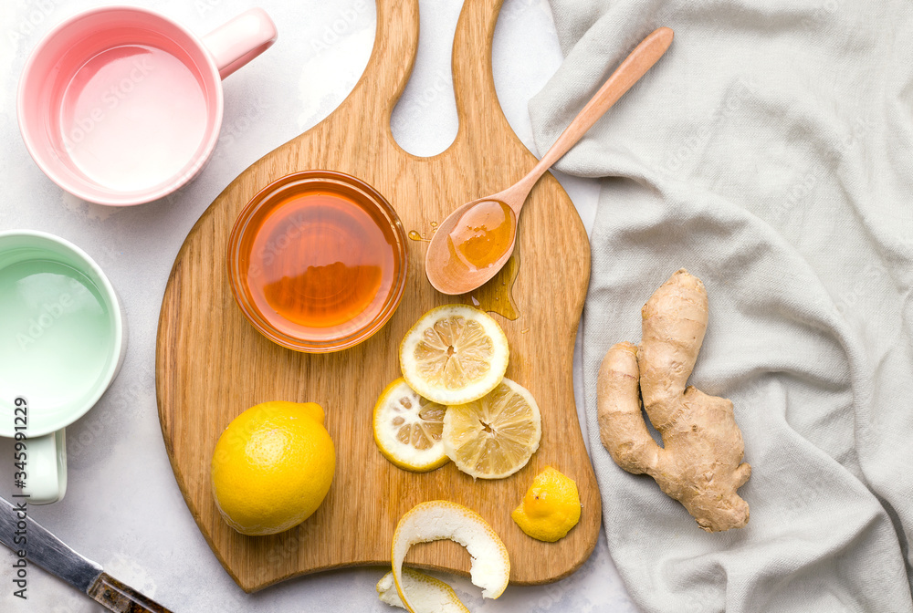 Fototapeta premium Making tea with lemon and ginger on a wooden board. virus products concept