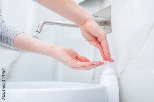 Woman washing hands with foam soap. Hygiene  preventing coronavirus