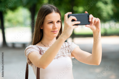 Woman using her mobile phone to take a photo