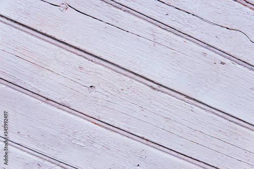 Background of vintage pastel white old natural wood diagonal planks. Dark aged empty tree rustic textured board. Closeup view surface of retro board vintage light warm interior with shadows.