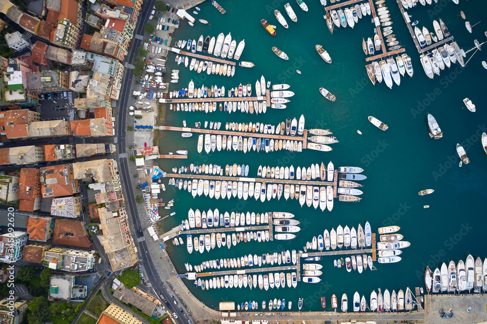 Fototapeta premium Top view on a harbor with moored sea ships, yachts and sailboats in Ligurian Sea. Santa Margherita Ligure is an italian riviera near Portofino and Genoa.